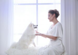 A woman and her dog share a tender moment.